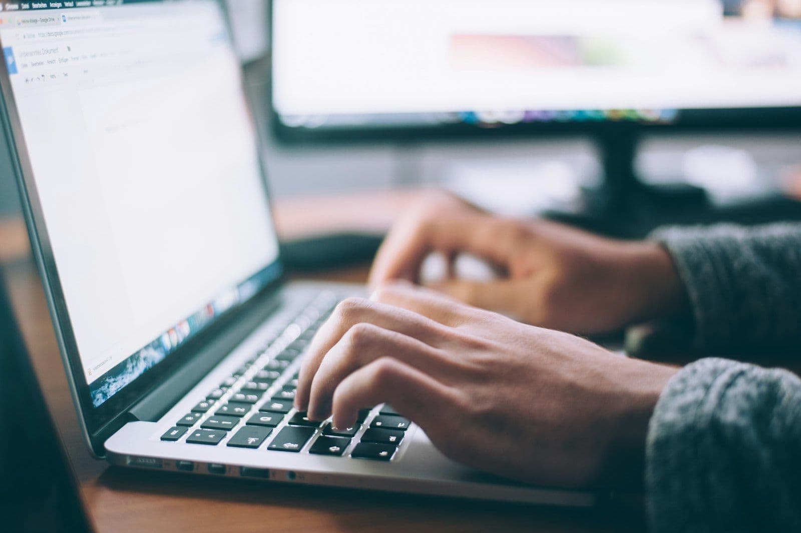 Hands at a keyboard, writing legal content for the public