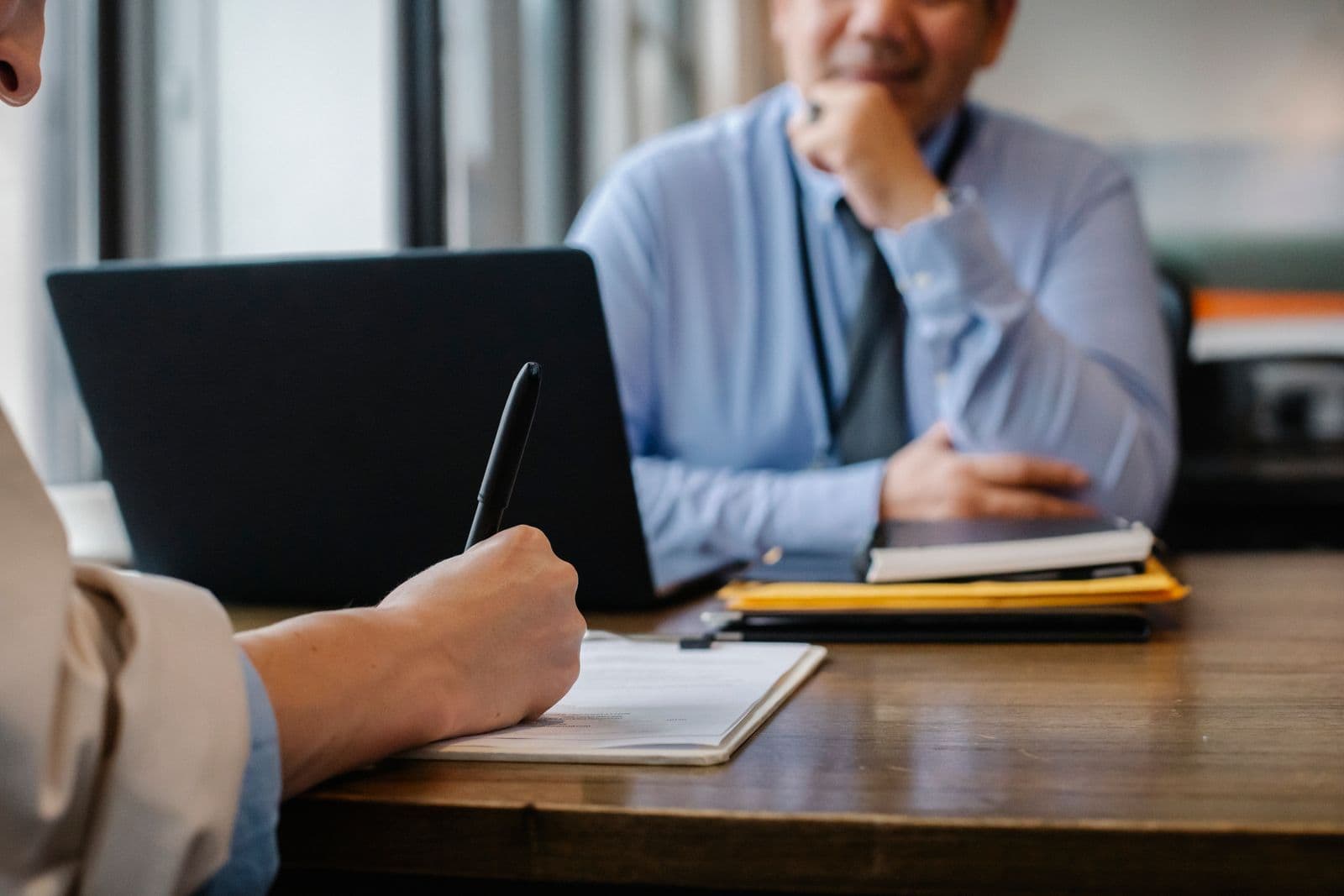 A solicitor advising a client across the desk