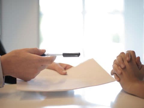 An adviser guiding the parties through a document at the table