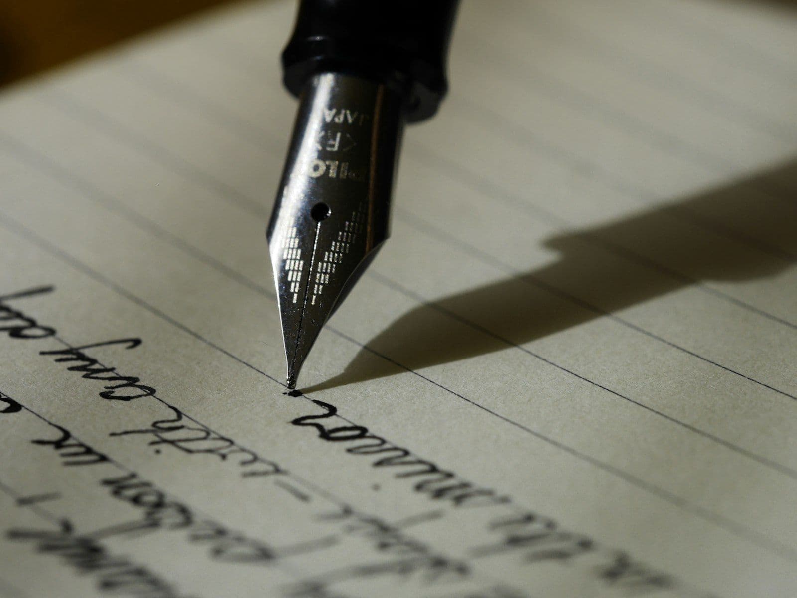 Drafting by hand with a fountain pen on plain paper