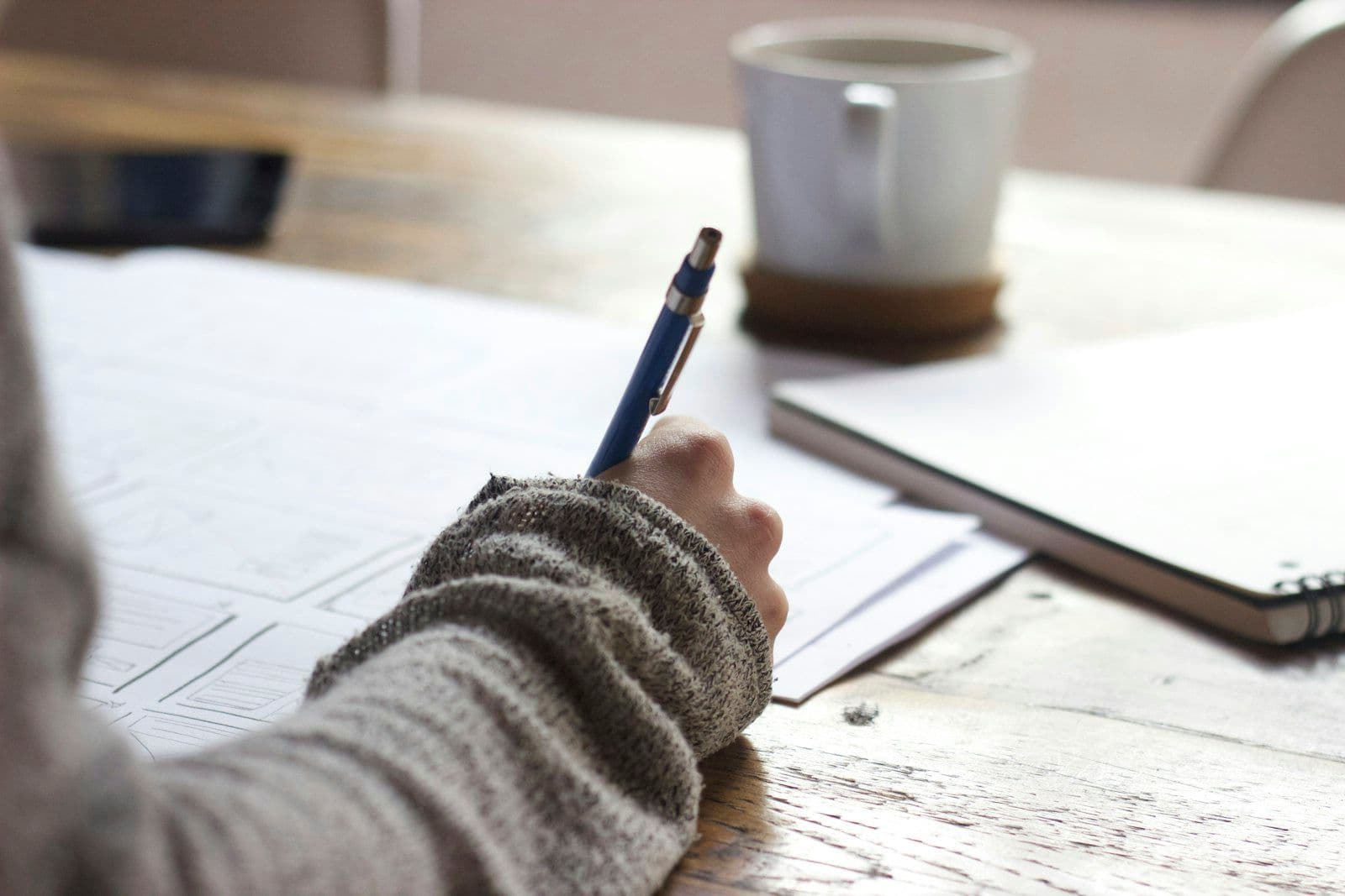 Preparation notes and coffee on a desk the week before mediation