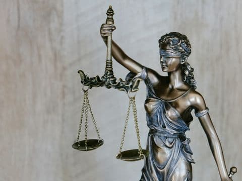 The figure of Lady Justice holding the scales